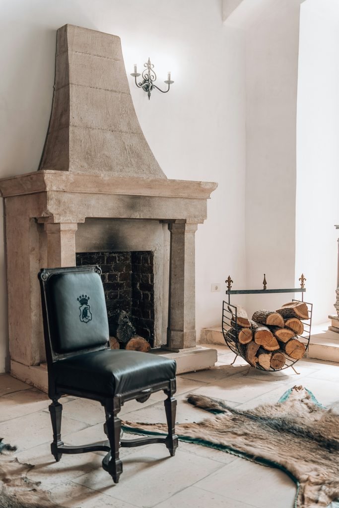 Rustic limestone fireplace in a French Country interior