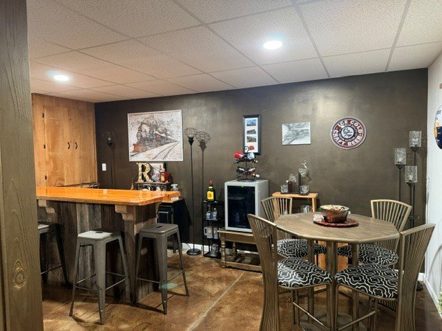 Blackened bronze accent wall behind the basement bar